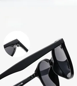 Detail view showing flexible hinge and high quality painting on black round frame sunglasses