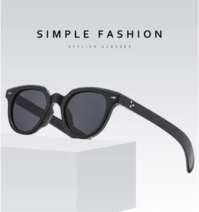 Detail view of oval sunglasses with star-shaped metal rivet accents on the black frame
