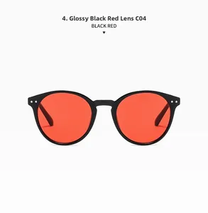 Front detail of round vintage sunglasses in glossy black with red lenses and rivet accents