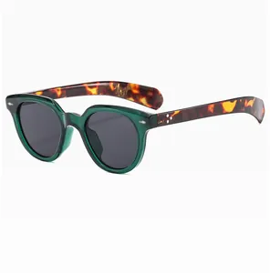 Close-up of translucent dark green frame with tortoise temples and silver metal rivets