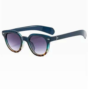 Detail view of oval leopard sunglasses with star-shaped metal studs on transparent frame