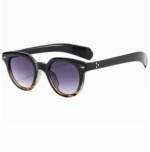 Close-up of retro oval sunglasses with purple gradient lenses and silver dot rivets