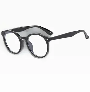 Detail of classic black round glasses frame featuring silver rivet accents on pure white back