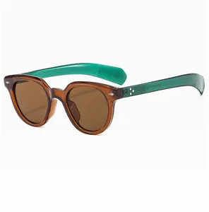 Detailed macro view of retro oval sunglasses with green temples and decorative star rivets