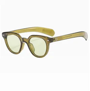 Detailed macro view of retro oval sunglasses with transparent olive green frames and text
