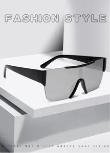 Flat silver mirror surface of frameless shield sunglasses on minimalist geometric backdrop
