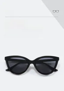 Detail view of stylish black cat eye sunglasses frame and dark grey fashion lenses