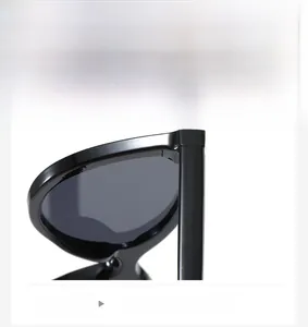 Detail of high-gloss black sunglasses hinge showing smooth temple and frame connection