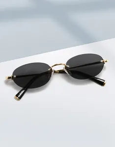 Detailed close-up of oval rimless sunglasses with gold metal bridge and model 8126 text