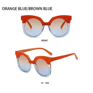 Détail de lunettes de soleil œil-de-chat rondes avec texture orange et verres dégradés