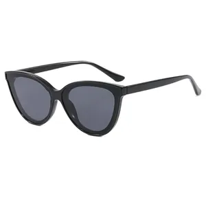 Retro black cat-eye sunglasses with dark gray lenses and minimalist contrast design