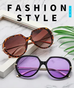 Detail of oversized sunglasses with tortoise and black frames and gold metal hinges
