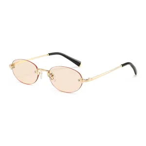 Minimalist oval rimless sunglasses with gold metal frame and orange lenses on white background