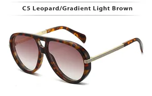 Detail of leopard print double bridge sunglasses with golden metal temples and gradient lenses