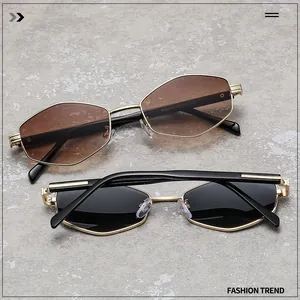 Detail of geometric polygonal sunglasses with gold metal frames and tinted lenses