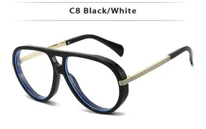 Detail view of vintage pilot sunglasses with black frame and golden striped metal temples
