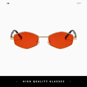 Detail of trendy gold metal hexagonal sunglasses with vibrant orange tinted lenses