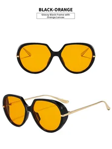 Detail of trendy black frame sunglasses with orange lenses and gold metal temples