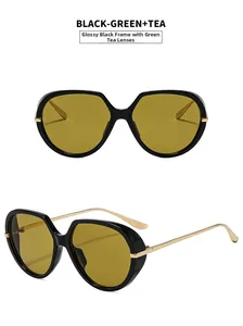 Detail view of stylish oversized sunglasses with gold metal temples and tea lenses