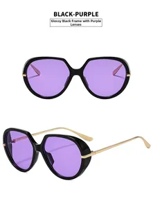 Detail view of stylish oversized black frame sunglasses with purple lenses and gold metal arms