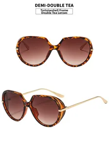 Detail view of demi frame sunglasses with tea gradient lenses and gold metal temples