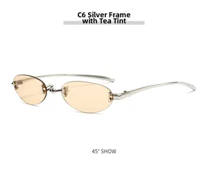 Detail of rimless oval sunglasses with thin silver metal temples and brown lenses