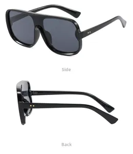 Detail view of black oversized square sunglasses with gold star rivets on the side