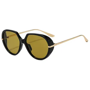 Vintage oversized sunglasses with black frame, amber lenses and slim gold metal temples