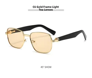 Detail of vintage square sunglasses featuring gold metal frames and light tea lenses