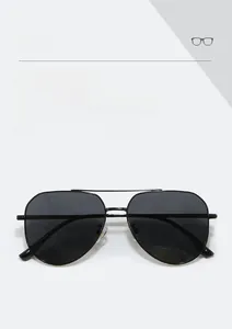 Close-up of classic black aviator sunglasses with thin metal frame and fashion eyewear logo