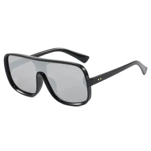 Modern black flat-top oversized sunglasses with dark grey lenses and gold accents