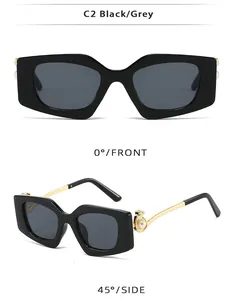 Detail view of square black sunglasses with pearl accents and golden metal temples