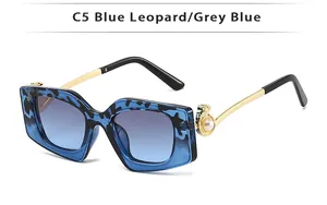 Detail of square blue leopard sunglasses with pearl accents and gradient lenses