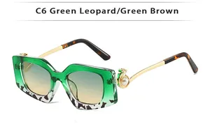Detail of gold metal temples with pearl accents on square leopard print sunglasses