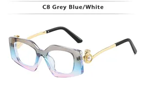 Detail of square sunglasses with gradient lenses, gold metal temples and pearl accent