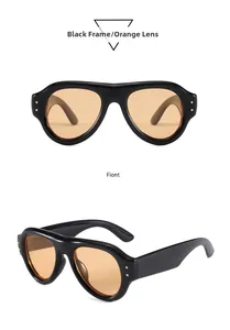 Detailansicht der schwarzen klobigen Sonnenbrille mit orangen Gläsern und Goldnieten