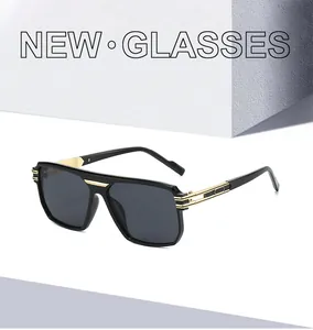 Detail of square black sunglasses with gold metal bridge and luxury temple accents