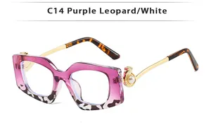 Detail of square glasses frame with purple leopard pattern and white bead decoration