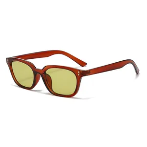 Vintage light yellow sunglasses with amber frames and silver rivets for a retro look
