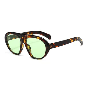 Vintage oversized tortoiseshell sunglasses with green lenses shown in a side profile view
