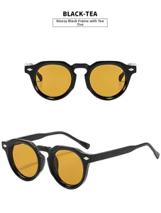 Detail view of glossy black round sunglasses with tea lenses and silver diamond rivets