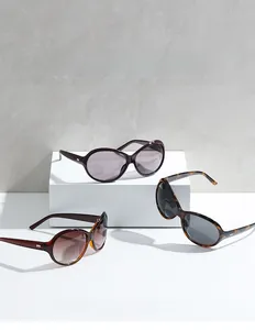 Detail of stylish oversized sunglasses with silver wing accents on the temples