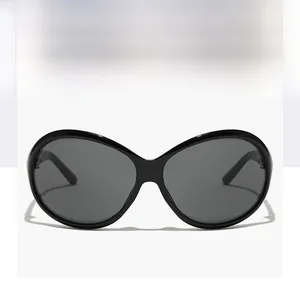 Detailed view of oversized butterfly sunglasses with polished black frames and grey lenses