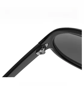Macro shot of durable silver metal hinges on stylish oversized black sunglasses