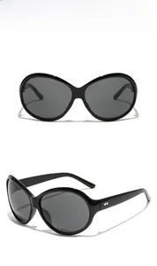 Detail of oversized black cat-eye sunglasses with silver heart accents on temple joints