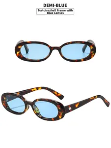 Detail view of oval tortoiseshell frame sunglasses with vibrant blue lenses for women
