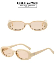 Detail view of oval beige frames with champagne lenses and side metal accents