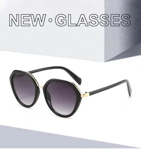 Detail of polygon sunglasses with gradient purple lenses and golden metal hinge accents