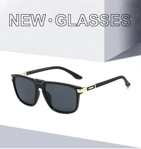 Detail of square black sunglasses showing gold metal hinges and textured quilted temples