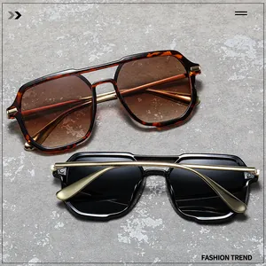 Detail of square double-bridge sunglasses in tortoiseshell and black with gold metal temples